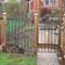 iron fencing with solid bar hoop pickets and single gate with arch top and hooped pickets galvanized and powder coated patricians bronze