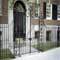 Iron fencing 2-line style with forged post panels and forged gate with scroll top